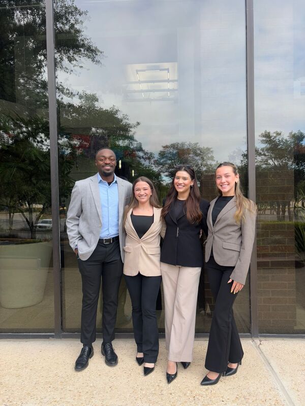 Four Skyline Marketing Agency team members outside an office building