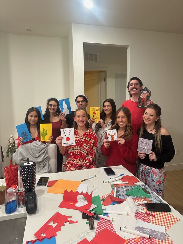 Skyline Marketing Agency team members holding handmade holiday cards