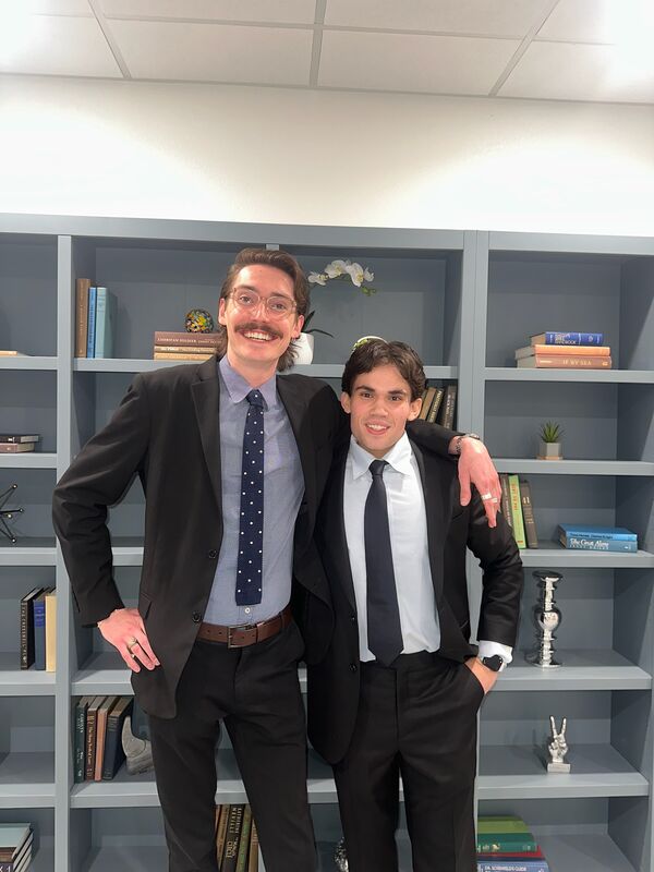 Two Skyline Marketing Agency team members in suits